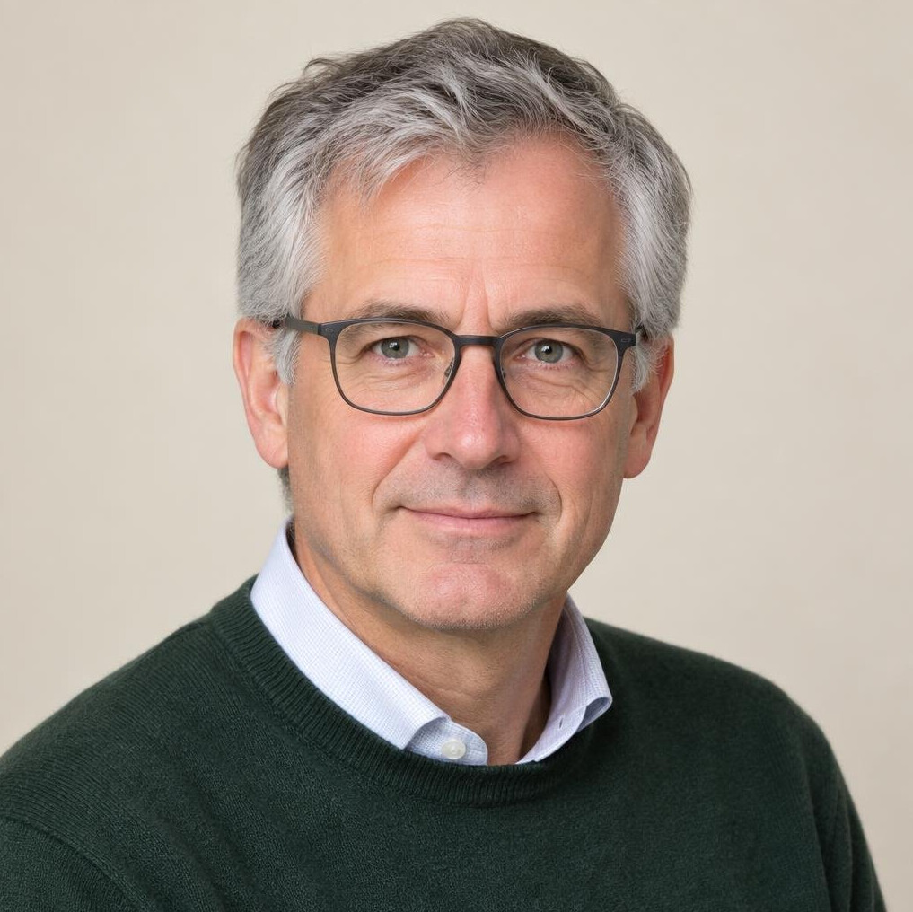 Studio portrait of a Belgian man with grey hair and glasses